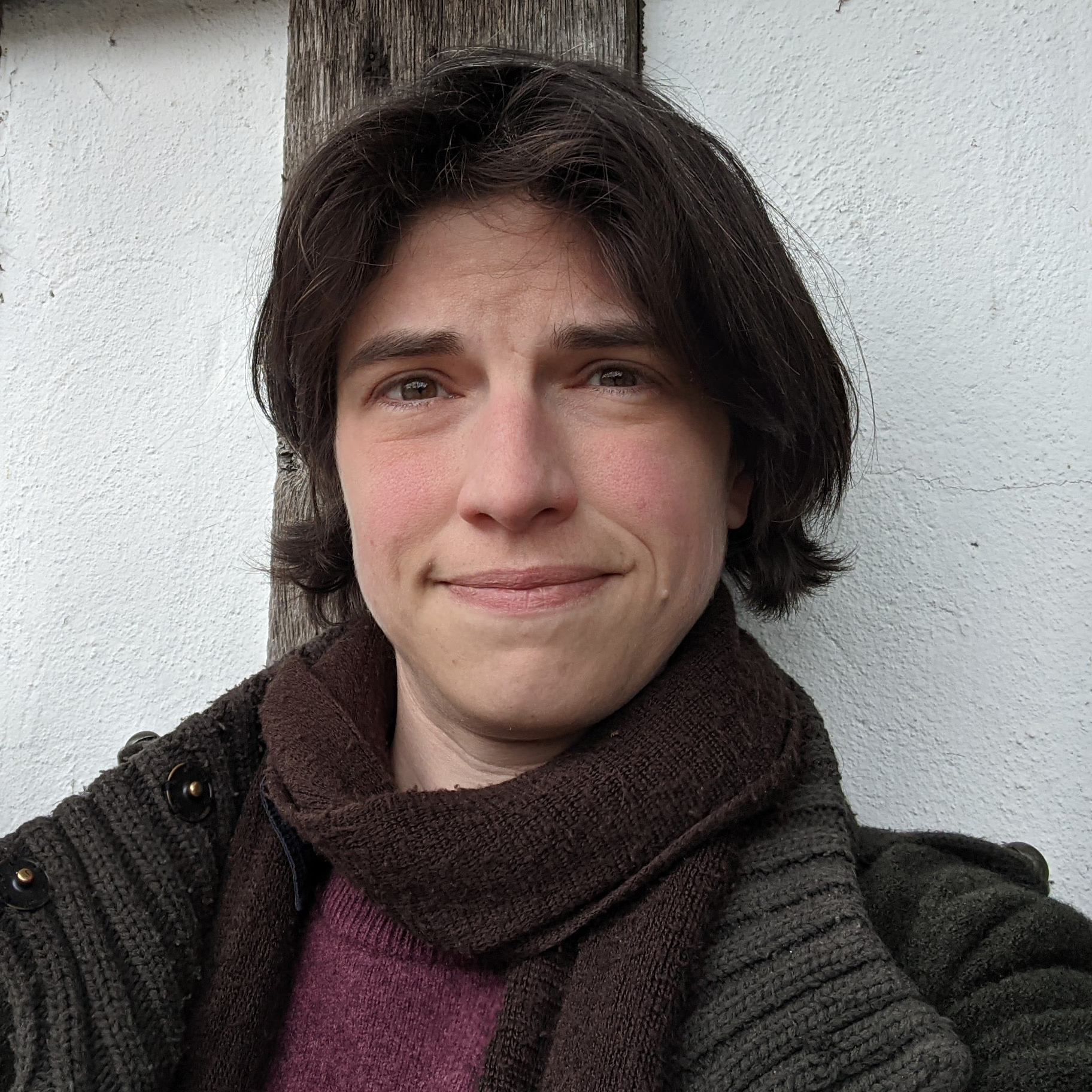 A photo of a middle-aged woman with shortish hair in a scarf and coat