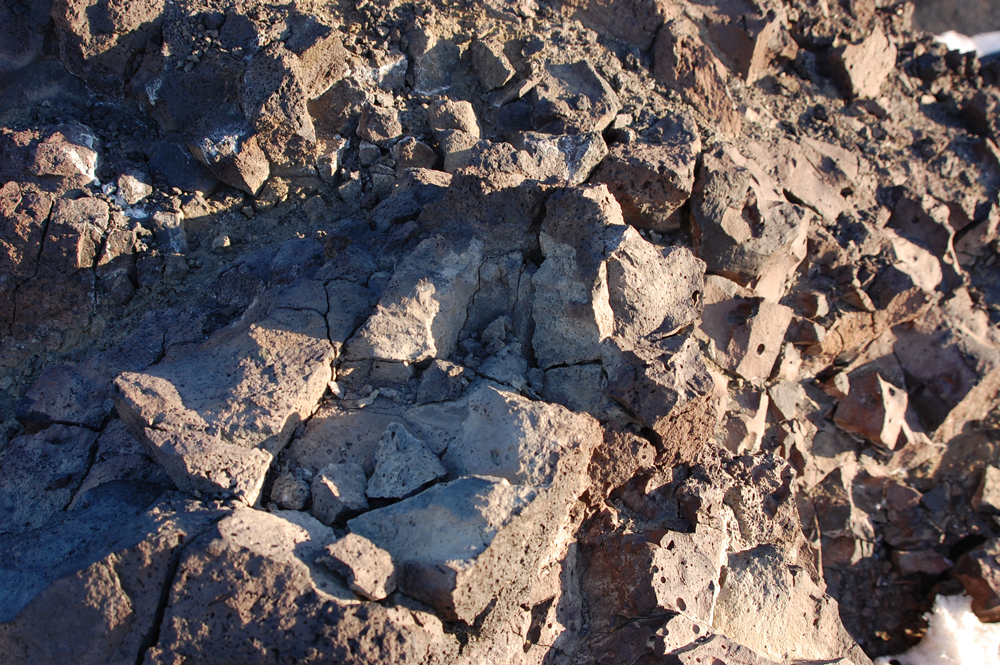 A closeup of the rock composing Arrival Heights, broken up into increasingly smaller pieces. The rock is full of bubbles, from its volcanic origins. Some of it is cristed with a mineral salt.