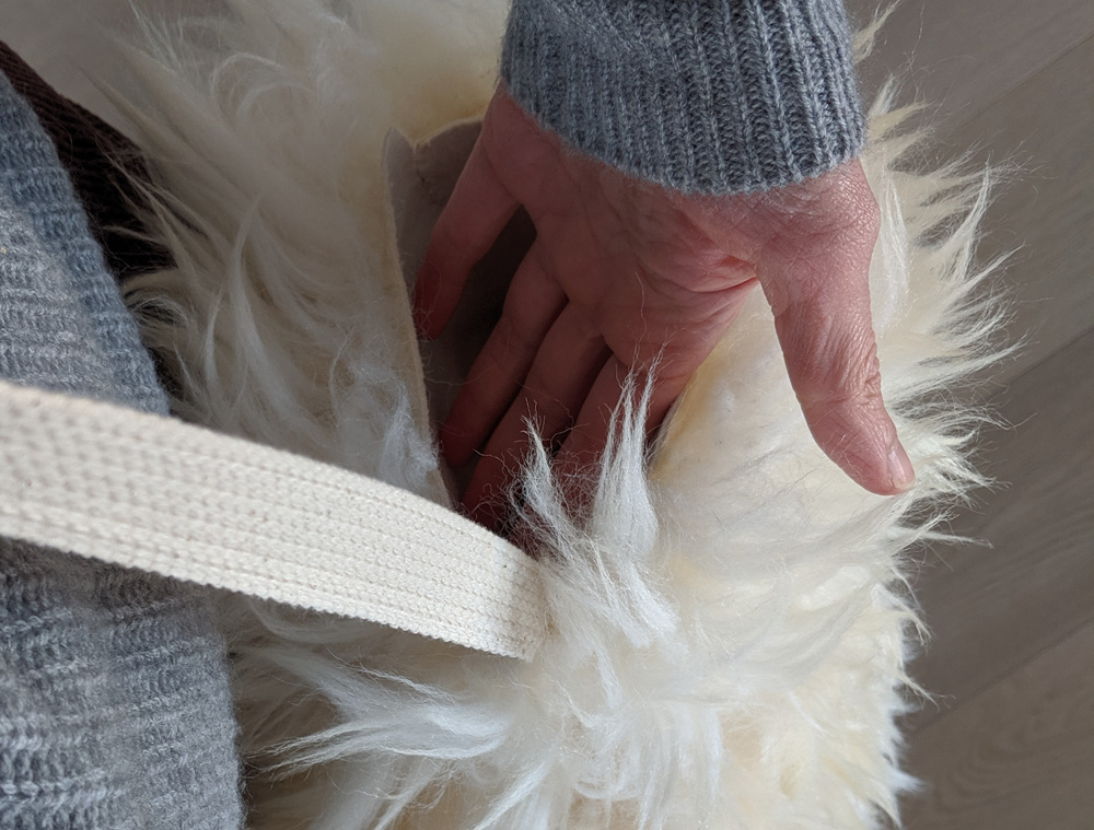 My hand in the opening of the finished fleece mitt