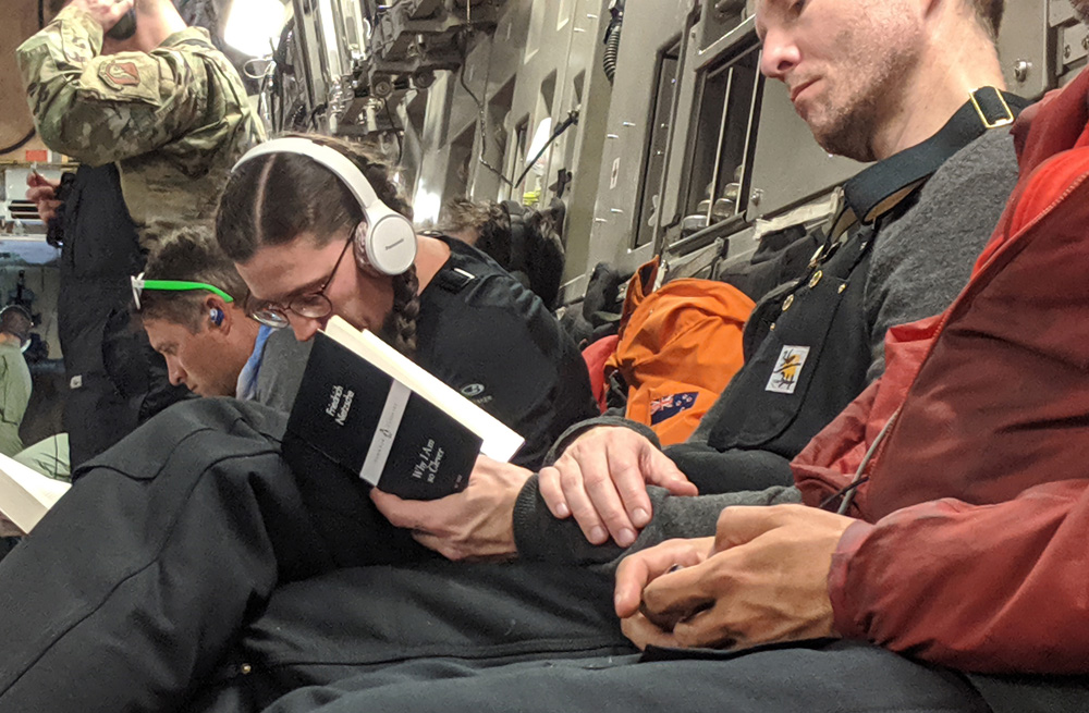 A passenger on an Antarctic-bound C-17 reads Friederich Nietzsche's book 'Why I Am So Clever.'